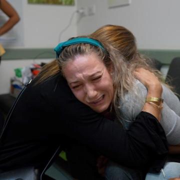 Sabin - a victim being comforted by UIA representative in Israel 