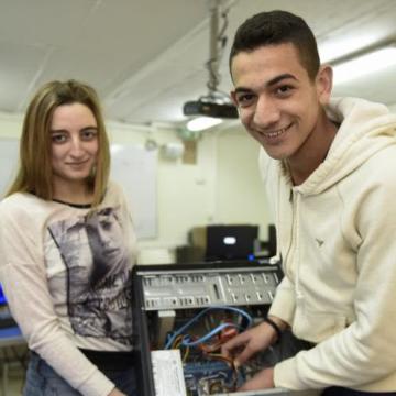 Two students learning how to build a computer