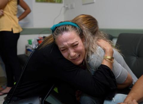 Sabin - a victim being comforted by UIA representative in Israel 