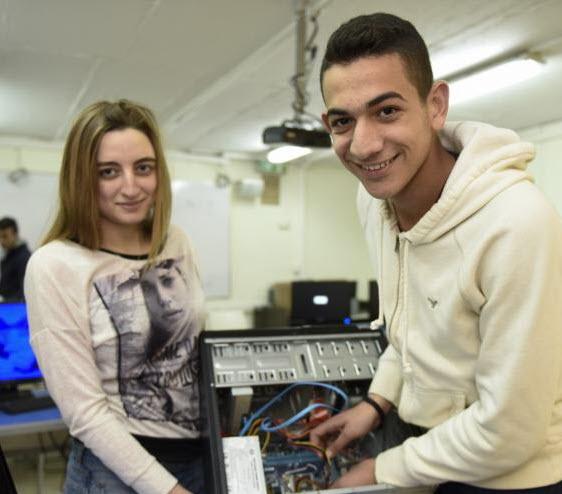 Two students learning how to build a computer